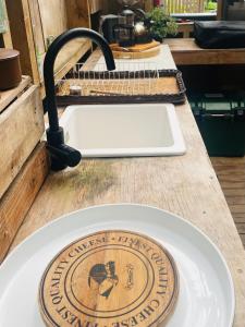 a plate on a counter with a kitchen sink at The kauri Tree Pod - Off Grid Experience in Levin