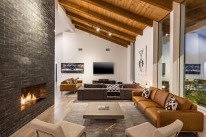 a living room with a couch and a fireplace at Luxury Micro-Resort, Theater, Sauna, Heated Pool in Phoenix