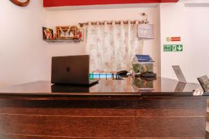an office with a desk with a laptop on it at Super OYO 40825 Jeevan Residency in Mysore