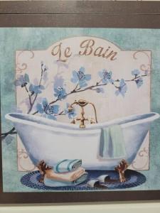 a picture of a white bath tub with a sink at Apartamento com varanda Reserva do Sahy in Mangaratiba