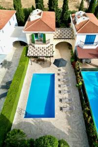 an aerial view of a house with two swimming pools at Villa Lorena Protaras in Protaras