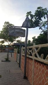 a street sign in front of a fence at Santo Amaro Chalés in Santo Amaro