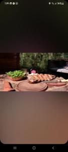 a table with meat and vegetables on top at cabañas y camping jv in Leandro N. Alem
