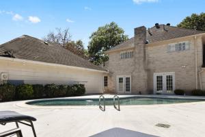 a house with a swimming pool in front of a house at Houston Luxury 4br/3ba and Pool in Sugar Land