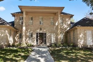 a large brick house with a front yard at Houston Luxury 4br/3ba and Pool in Sugar Land