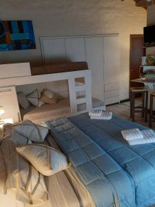a bedroom with a large blue bed with pillows at Apart Los Cerrillos in Balcarce