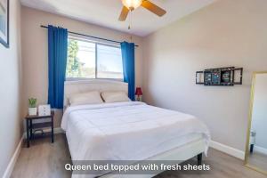 Un dormitorio con una cama blanca con cortinas azules y una ventana en Entire Private 3-Bedroom Townhouse with King Bed near Bay & Beach, No Deposit en Chula Vista
