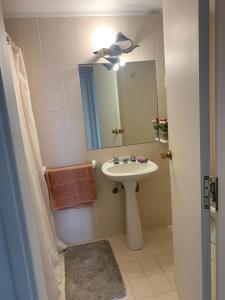a bathroom with a sink and a mirror at La mano in Punta del Este