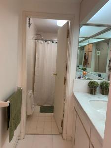 a bathroom with a shower and a sink and a mirror at La mano in Punta del Este
