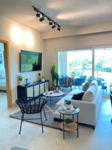 a living room with a couch and two tables at A Hidden Gem in the Caribbean Paradise in María Grande