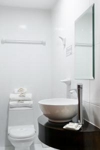 a white bathroom with a sink and a toilet at El puente Hotel Boutique in Arequipa