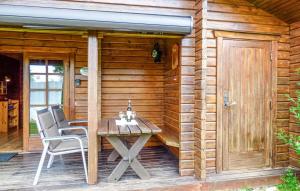 a wooden cabin with a table and chairs on a patio at Ferienhaus Erms 87 in Hayingen