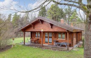 a log cabin in the woods with a porch at Ferienhaus Tauber 17 in Hayingen