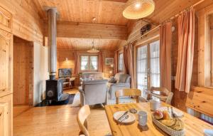 a living room with a table and chairs and a living room at Ferienhaus Tauber 82 in Hayingen