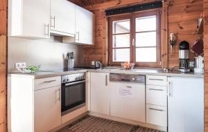 a kitchen with white appliances and a window at Ferienhaus Neckar 70 in Hayingen