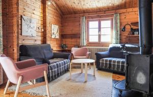 a living room with a couch and chairs and a stove at Ferienhaus Neckar 70 in Hayingen