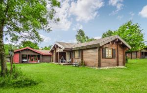 a log home with a green yard at Ferienhaus Donau 89 in Hayingen