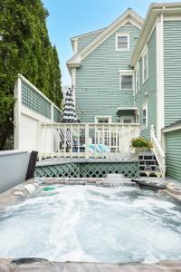 a house with a large pool in front of a house at The Front Porch Vacation Rentals in Bristol