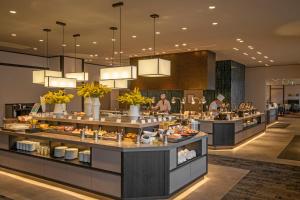 a restaurant with a buffet line with food on display at KAMENOI HOTEL Kusatsu Yubatake in Kusatsu