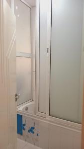 a bathroom with a shower with a glass door at Kalthoum in Chott Meriem