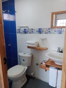 a bathroom with a toilet and a sink at Posada MCKELLER in San Luis +8 photos