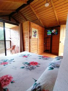 a bedroom with a bed with flowers on it at Mario's Lodge Providencia in El Copey
