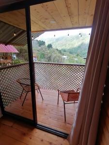 Blick auf eine Terrasse mit 2 Stühlen und einem Tisch in der Unterkunft Mario's Lodge Providencia in Copey