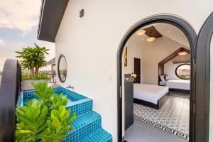 a hotel room with a pool and a bedroom at Villa Dương Hội An in Hoi An