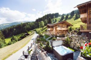 a large house with a hot tub on a patio at Sporer-Alm in Rohrberg