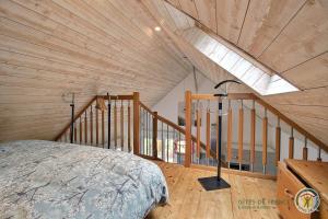 ein Schlafzimmer im Dachgeschoss mit einem Bett und einem Dachfenster in der Unterkunft Au bord du ruisseau in Saint-Quay-Perros