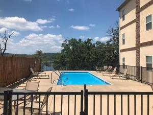 a swimming pool on a patio next to a building at Table Rock Sunset Condo with Boat Slip in Branson