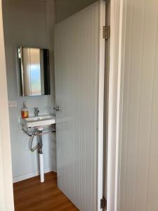 a bathroom with a sink and a mirror at Mario's Lodge Providencia in El Copey