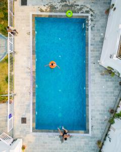 an overhead view of a large pool of water with a fish at The White House Villa 8 bedroom with Swimming Pool in Kathmandu