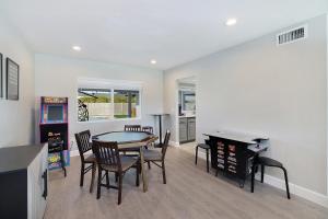 a living room with a dining room table and chairs at Pegasus - Modern Tempe Getaway with Pool & Game Room in Tempe