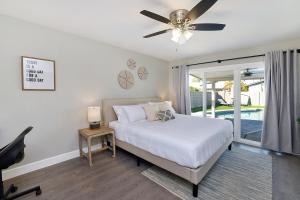 a bedroom with a bed and a ceiling fan at Pegasus - Modern Tempe Getaway with Pool & Game Room in Tempe