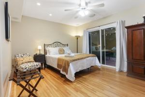 a bedroom with a bed and a ceiling fan at La Playa - Charming Bayside Bungalow in San Diego +13 photos