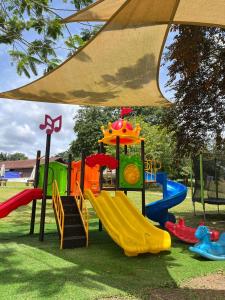 parco giochi con scivolo e ombrellone di Glamping Wetland Putrajaya a Putrajaya