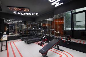 a gym with treadmills and elliptical machines at Shenzhen Futian Xiameilin Metro Station CitiGO Hotel in Shenzhen