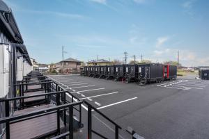 a row of train cars parked in a parking lot at HOTEL R9 The Yard 小美玉 in Omitama