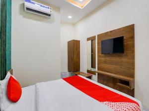 a bedroom with a bed and a flat screen tv at Hotel King View in Ahmedabad