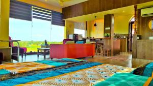 a living room with two beds and a kitchen at Shivalaya Boutique Stay in Tiruvannāmalai