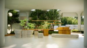 a lobby with a table and chairs and trees at Oshom Bali in Tanah Lot