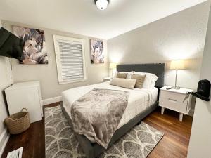 a small bedroom with a bed and a night stand at Vibrant City Home 4BD 2BA in Brockton