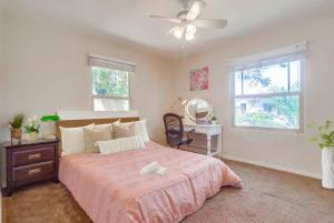 a bedroom with a bed with a ceiling fan and a desk at Entire Private 3-Bedroom Home with Baby Crib, Wi-Fi & Laundry in San Diego