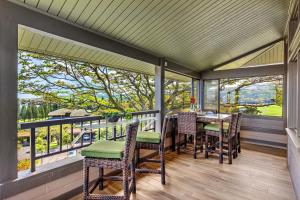 a screened in porch with a table and chairs at Kapalua Ridge Villa 1723-24 in Kahana