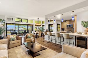 an open kitchen and living room with a bar at Kapalua Ridge Villa 1723-24 in Kahana