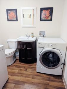 a bathroom with a washing machine and a sink at Uptown area, Cozy king Suite, quiet and private, free parking, walk to restaurants in Charlotte +12 photos