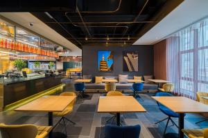 a restaurant with wooden tables and chairs at CitiGO Hotel Hongqiao Shanghai in Shanghai