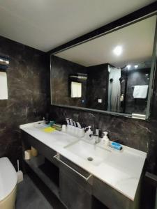 a bathroom with a white sink and a mirror at SPACE-VESSEL Base - Vacation STAY 42244v in Yufuin