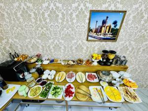 a buffet with many plates of food on a table at Samarkand Travel Hotel in Samarkand